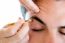 Man Removing Eyebrow Hairs With Tweezing