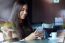 Beautiful Girl Using Her Mobile Phone In Cafe