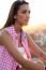 Pretty Girl Sitting On The Roof At Sunset