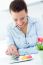 Woman Eating French Cookies At Home