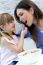 Child Eating Cereals With Her Mom In The Kitchen