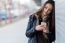 Young Beautiful Woman With Mobile Phone In The Street