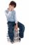 Young Boy Sitting Over Tower Of Books