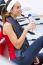 Young Woman Relaxing In The Gym After Making Exercise