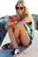 Beautiful Blonde Girl Sitting On The Roof With Mobile Phone