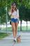 Beautiful Young Woman Walking With Her Dog In The Park