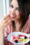 Cute Young Woman Eating Jelly Candies With A Fresh Smile