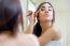 Beautiful Young Woman Making Make-up Near Mirror