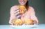 Happy Young Woman Eating Delicious Muffins