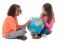 Two Little Girls Exploring A Globe