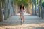 Pretty Young Girl Riding Bike In A Forest