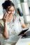 Pretty Young Woman Using Her Mobile Phone In The Office