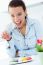 Woman Eating French Cookies At Home