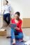 Young Couple With Digital Tablet Resting In Their New Home