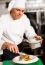 Chef Arranging Tossed Salad In A Bowl