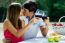 Attractive Couple Drinking Wine On Romantic Picnic In Countrysid