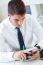 Young Handsome Man Working In His Office With Mobile Phone