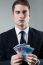 Young Man In Formalwear Holding Money