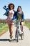 Two Beautiful Young Women With A Vintage Bike In The Field