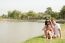 Family Sitting Near The Lake