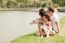 Family Sitting Near The Lake