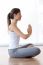 Beautiful Young Woman Doing Yoga Exercises At Home