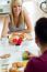 Happy Young Couple Enjoying Breakfast In The Kitchen