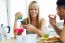 Happy Young Couple Enjoying Breakfast In The Kitchen