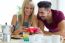 Happy Young Couple Enjoying Breakfast In The Kitchen