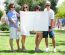 Teens With White Billboard Standing In Park