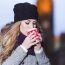 Attractive Young Stylish Blonde Girl Drinks Hot Drink From A Mug