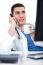 Doctor Talking Over Telephone And Having Coffee