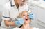 Female Dentist Inspecting Teeth Of Patient