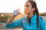 Portrait Of Young Woman Drinking Water After Running