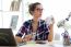 Beautiful Young Woman Drinking Coffee In Her Office