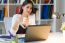 Pretty Young Woman Working With Laptop In Her Office