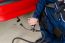 Mechanic Measuring Exhausts Of A Car In Garage