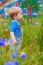 Cute Small Boy At The Field Of Flowers Having Good Time