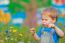 Cute Small Boy At The Field Of Flowers Having Good Time