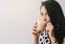 Woman Drinking Hot Latte Coffee At Cafe