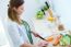 Pretty Young Woman Cutting Vegetables In The Kitchen