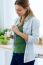 Pretty Young Woman Eating Yogurt In The Kitchen