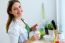 Pretty Young Woman Eating Yogurt In The Kitchen