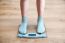 Girl's Legs Standing On The Scales