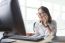 Young Working Woman Talking To Phone With Watching On Computer On Office Table Use For Business Connecting ,customer Service ,communication