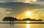 Two Children Standing On The Beach Watching The Sunrise