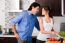 Couple Staring Each Other Eyes In The Kitchen