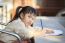 Asian Children With Yellow Pencil In Hand Doing School Home Work With Happiness Emotion