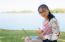 Young Girl With Laptop On The Grass