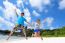 Father And Daughter Jumping On Beach At Thailand